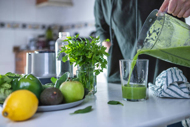 Woman preparing Avocado and apple smoothie