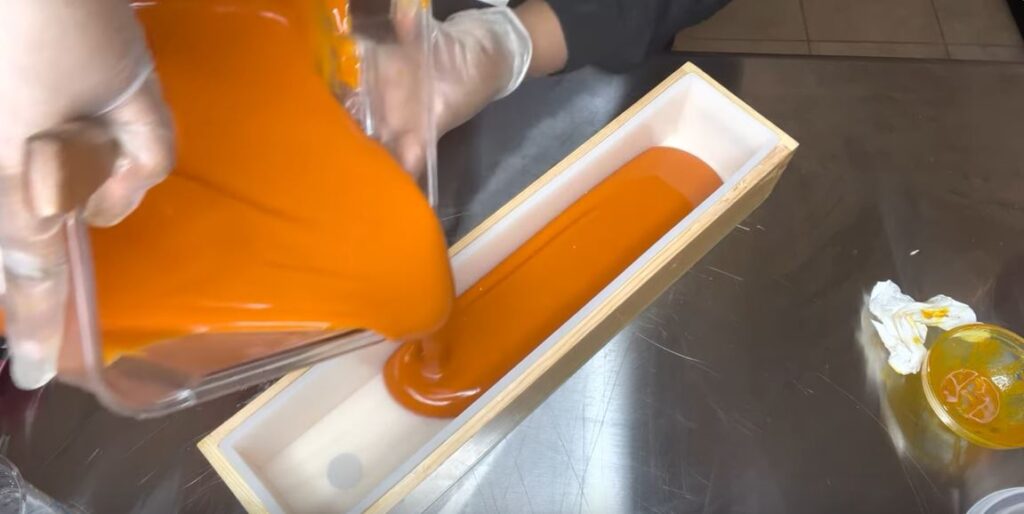 Filling the turmeric and honey soap soap in crate